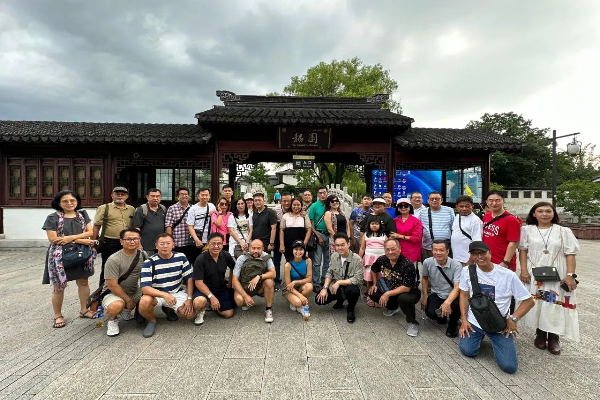 The delegation at the gate of a classical Chinese garden in Suzhou, between exhibition days.